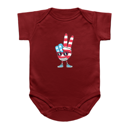 A red blue short-sleeve 4th of July infant bodysuit featuring a cartoon graphic of a hand making a peace sign with red and white stripes and blue accents, set against a plain white background.