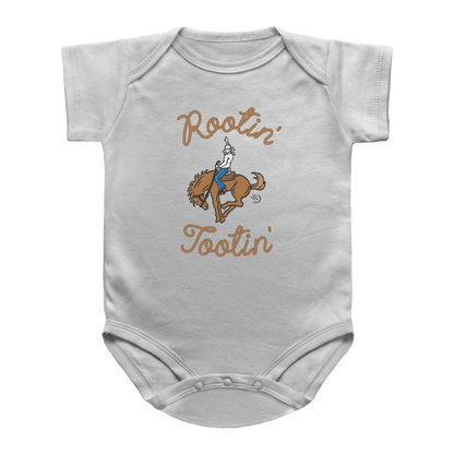 A white short-sleeve infant onesie with a graphic of a cowboy riding a bucking horse, farting and the words Rootin&