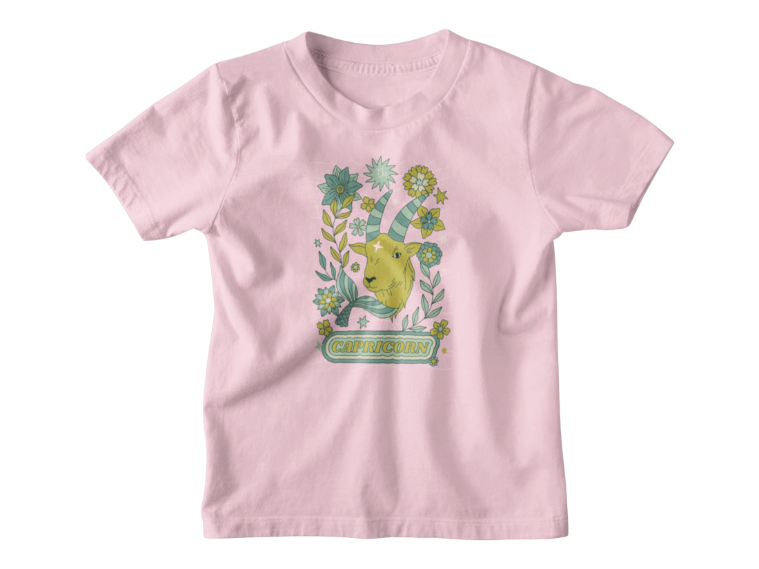 A pink kids shirt for Capricorn astrology sign with a tarot goat.