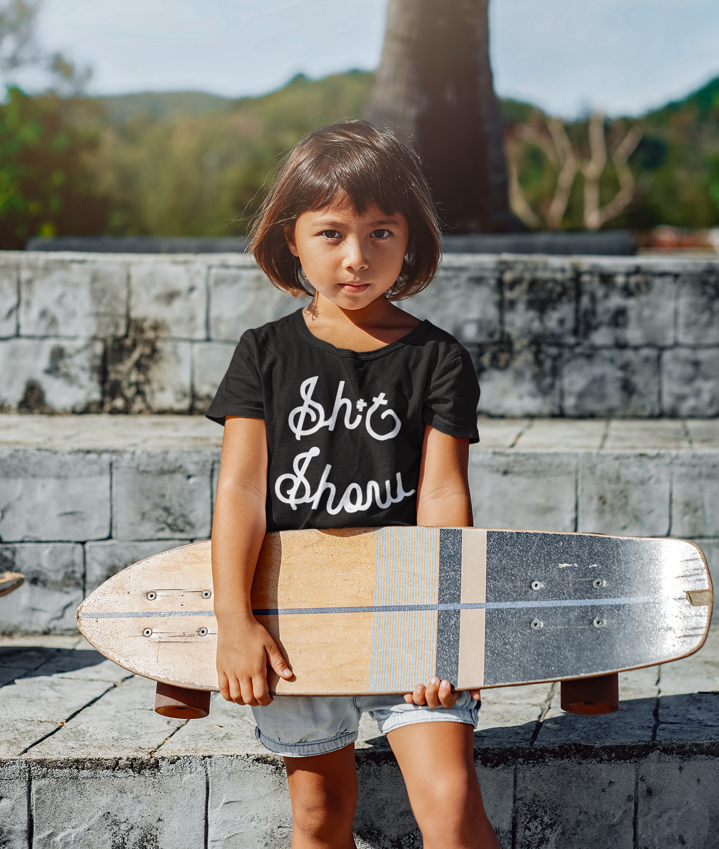 Girl with a skateboard and shirt that says shit show